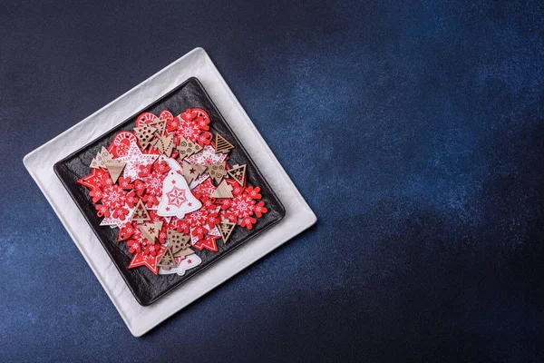Christmas decorations and gingerbreads on a dark concrete table. Preparing and decorating the house for holiday