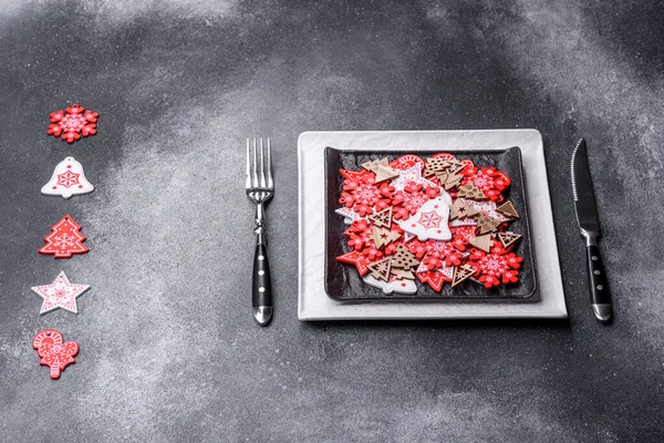 Christmas decorations and gingerbreads on a dark concrete table. Preparing and decorating the house for holiday