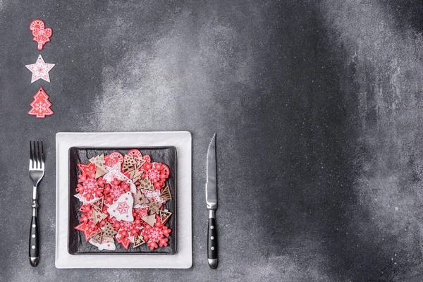 Christmas decorations and gingerbreads on a dark concrete table. Preparing and decorating the house for holiday