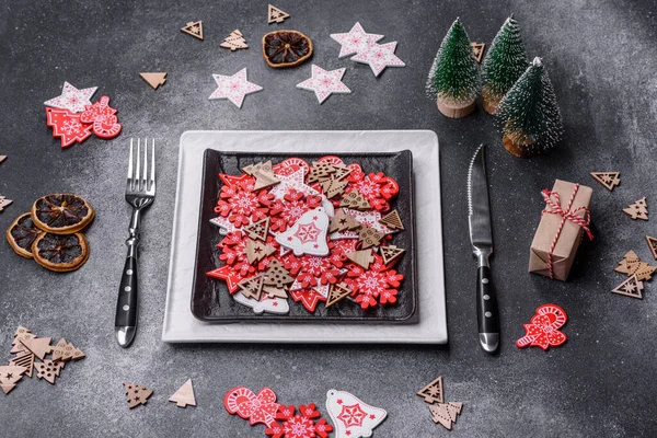 Christmas decorations and gingerbreads on a dark concrete table. Preparing and decorating the house for holiday