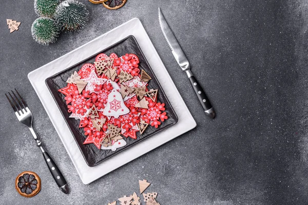 Christmas decorations and gingerbreads on a dark concrete table. Preparing and decorating the house for holiday