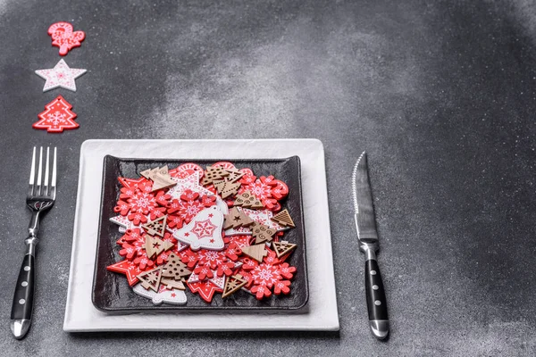 Christmas decorations and gingerbreads on a dark concrete table. Preparing and decorating the house for holiday