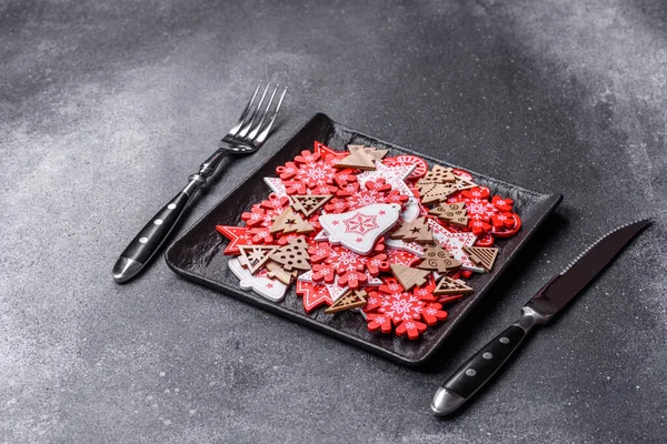 Christmas decorations and gingerbreads on a dark concrete table. Preparing and decorating the house for holiday