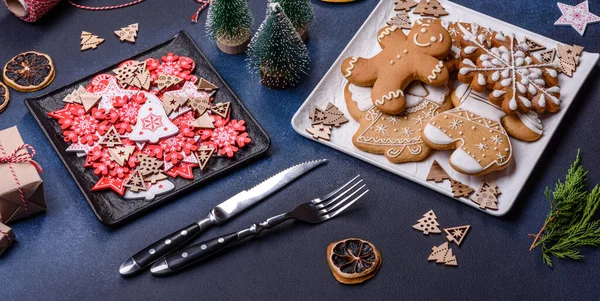 Christmas decorations and gingerbreads on a dark concrete table. Preparing and decorating the house for holiday