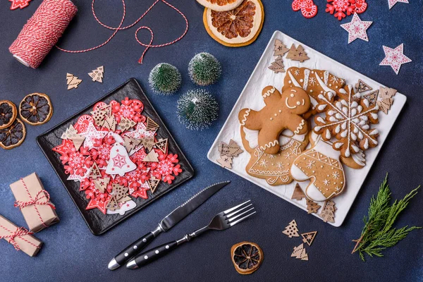 Christmas decorations and gingerbreads on a dark concrete table. Preparing and decorating the house for holiday