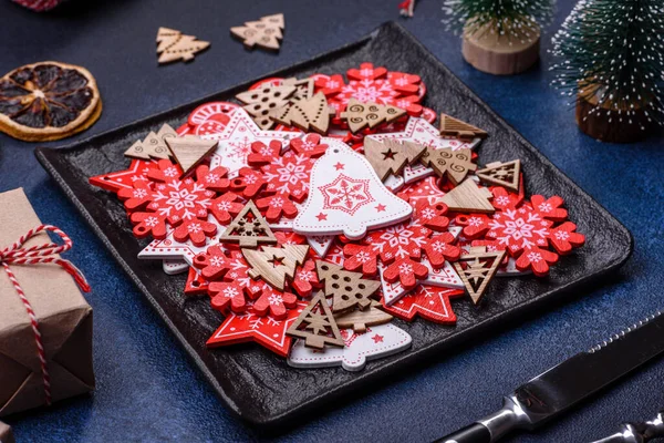 Christmas decorations and gingerbreads on a dark concrete table. Preparing and decorating the house for holiday
