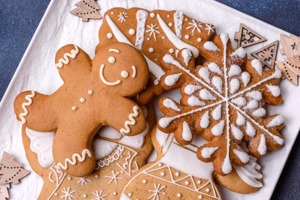 Christmas decorations and gingerbreads on a dark concrete table. Preparing and decorating the house for holiday