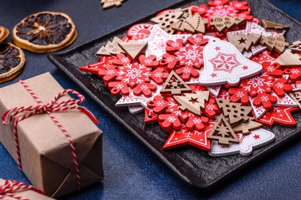 Christmas decorations and gingerbreads on a dark concrete table. Preparing and decorating the house for holiday