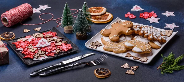 Christmas decorations and gingerbreads on a dark concrete table. Preparing and decorating the house for holiday