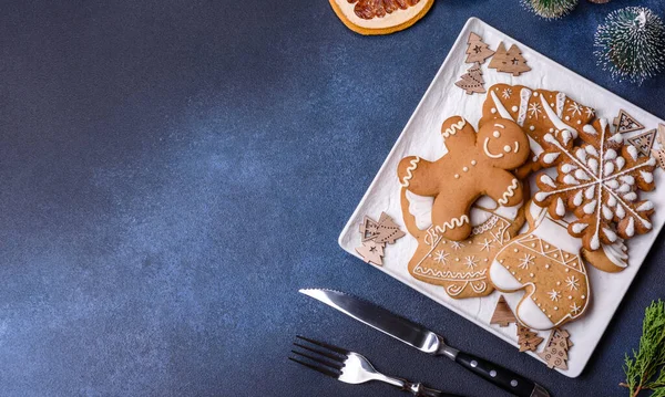 Christmas decorations and gingerbreads on a dark concrete table. Preparing and decorating the house for holiday