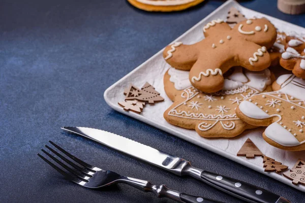 Christmas decorations and gingerbreads on a dark concrete table. Preparing and decorating the house for holiday