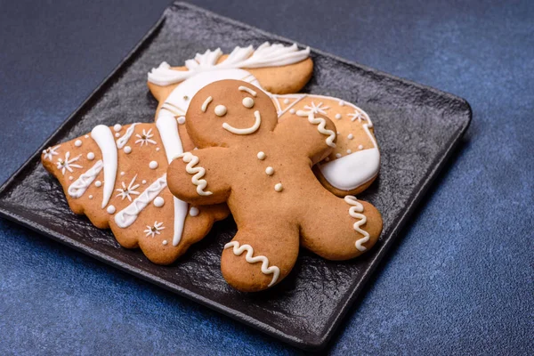 Christmas decorations and gingerbreads on a dark concrete table. Preparing and decorating the house for holiday