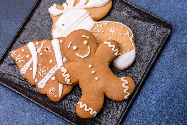 Christmas decorations and gingerbreads on a dark concrete table. Preparing and decorating the house for holiday