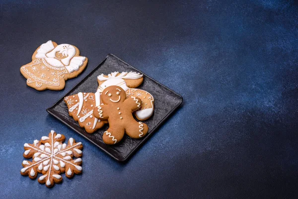 Christmas decorations and gingerbreads on a dark concrete table. Preparing and decorating the house for holiday