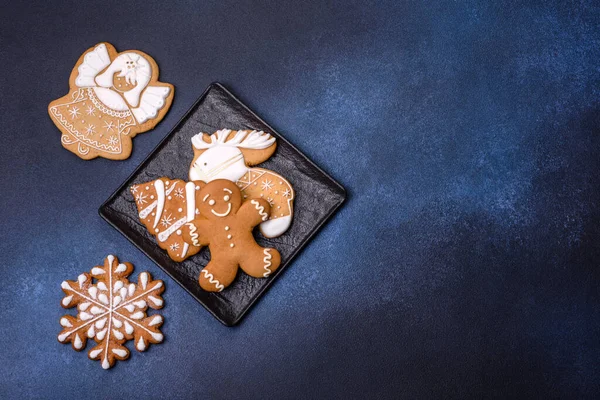 Christmas decorations and gingerbreads on a dark concrete table. Preparing and decorating the house for holiday
