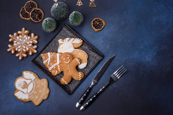 Christmas decorations and gingerbreads on a dark concrete table. Preparing and decorating the house for holiday