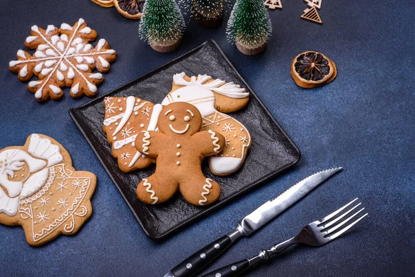 Christmas decorations and gingerbreads on a dark concrete table. Preparing and decorating the house for holiday