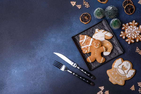 Christmas decorations and gingerbreads on a dark concrete table. Preparing and decorating the house for holiday