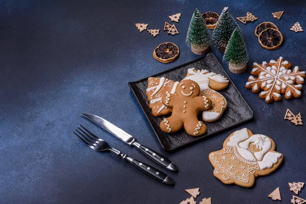 Christmas decorations and gingerbreads on a dark concrete table. Preparing and decorating the house for holiday