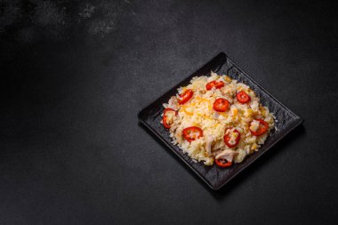 Homemade chinese fried rice with vegetables and a chicken served on a plate