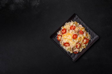 Homemade chinese fried rice with vegetables and a chicken served on a plate