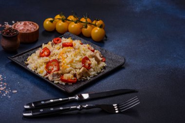 Homemade chinese fried rice with vegetables and a chicken served on a plate