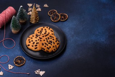 Christmas decorations and gingerbreads on a dark concrete table. Preparing and decorating the house for holiday