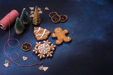 Christmas decorations and gingerbreads on a dark concrete table. Preparing and decorating the house for holiday