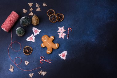 Christmas decorations and gingerbreads on a dark concrete table. Preparing and decorating the house for holiday