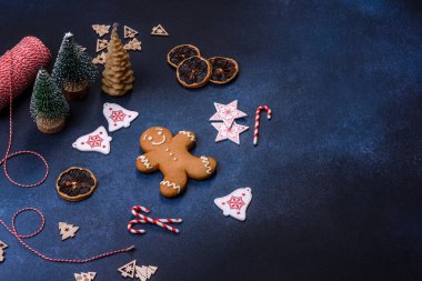 Christmas decorations and gingerbreads on a dark concrete table. Preparing and decorating the house for holiday