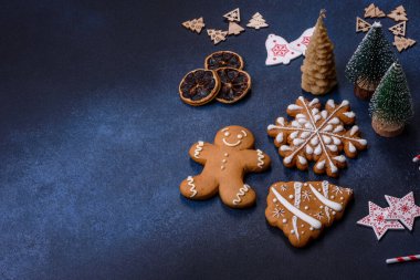 Christmas decorations and gingerbreads on a dark concrete table. Preparing and decorating the house for holiday