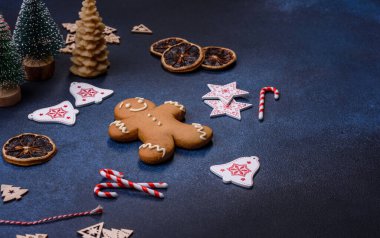Christmas decorations and gingerbreads on a dark concrete table. Preparing and decorating the house for holiday