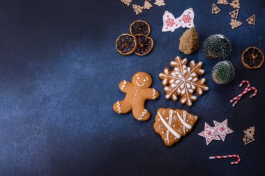 Christmas decorations and gingerbreads on a dark concrete table. Preparing and decorating the house for holiday