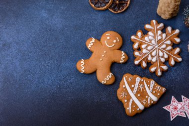 Christmas decorations and gingerbreads on a dark concrete table. Preparing and decorating the house for holiday