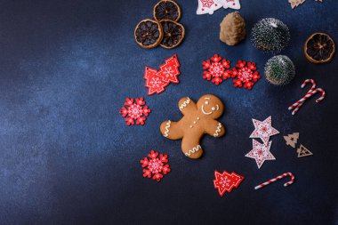 Christmas decorations and gingerbreads on a dark concrete table. Preparing and decorating the house for holiday