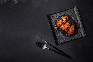 Dolma, stuffed grape leaves with rice and meat on a dark background. Caucasian and Turkish cuisine