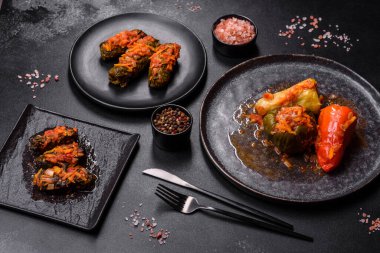 Dolma, stuffed grape leaves with rice and meat on a dark background. Caucasian and Turkish cuisine