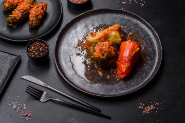 Dolma, stuffed grape leaves with rice and meat on a dark background. Caucasian and Turkish cuisine