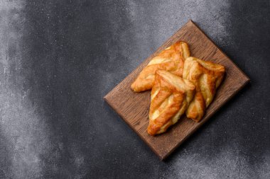 Delicious fresh cornmeal pastries with homemade cheese on a wooden cutting board. Delicious healthy breakfast