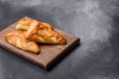 Delicious fresh cornmeal pastries with homemade cheese on a wooden cutting board. Delicious healthy breakfast