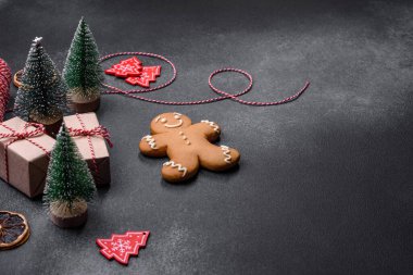 Christmas decorations and gingerbreads on a dark concrete table. Preparing and decorating the house for holiday