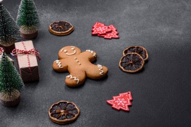 Christmas decorations and gingerbreads on a dark concrete table. Preparing and decorating the house for holiday