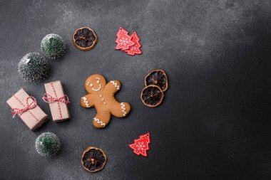 Christmas decorations and gingerbreads on a dark concrete table. Preparing and decorating the house for holiday