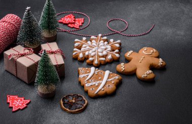 Christmas decorations and gingerbreads on a dark concrete table. Preparing and decorating the house for holiday