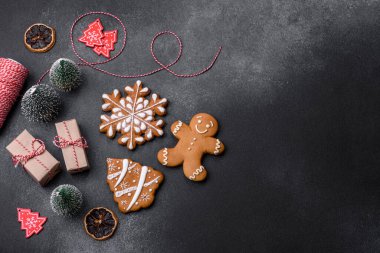 Christmas decorations and gingerbreads on a dark concrete table. Preparing and decorating the house for holiday