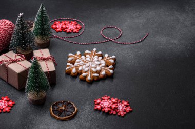 Christmas decorations and gingerbreads on a dark concrete table. Preparing and decorating the house for holiday