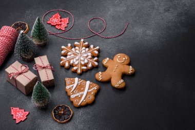 Christmas decorations and gingerbreads on a dark concrete table. Preparing and decorating the house for holiday
