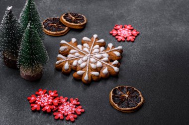 Christmas decorations and gingerbreads on a dark concrete table. Preparing and decorating the house for holiday