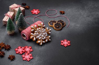 Christmas decorations and gingerbreads on a dark concrete table. Preparing and decorating the house for holiday
