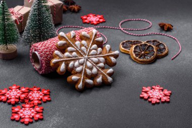 Christmas decorations and gingerbreads on a dark concrete table. Preparing and decorating the house for holiday